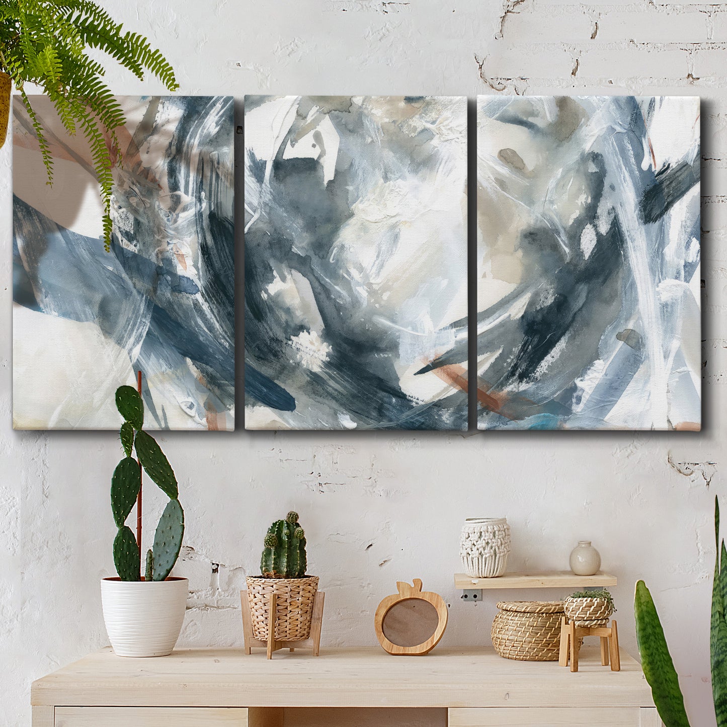Three-panel canvas wall art featuring repeating abstract geometric array, displayed in a boho-chic entryway above a console table.