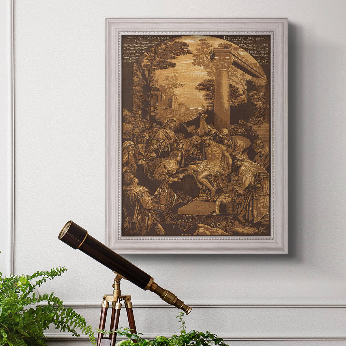 Monochrome religious painting of the raising of Lazarus by Leandro Bassano in an ornate weathered white frame displayed in a light-toned interior setting.