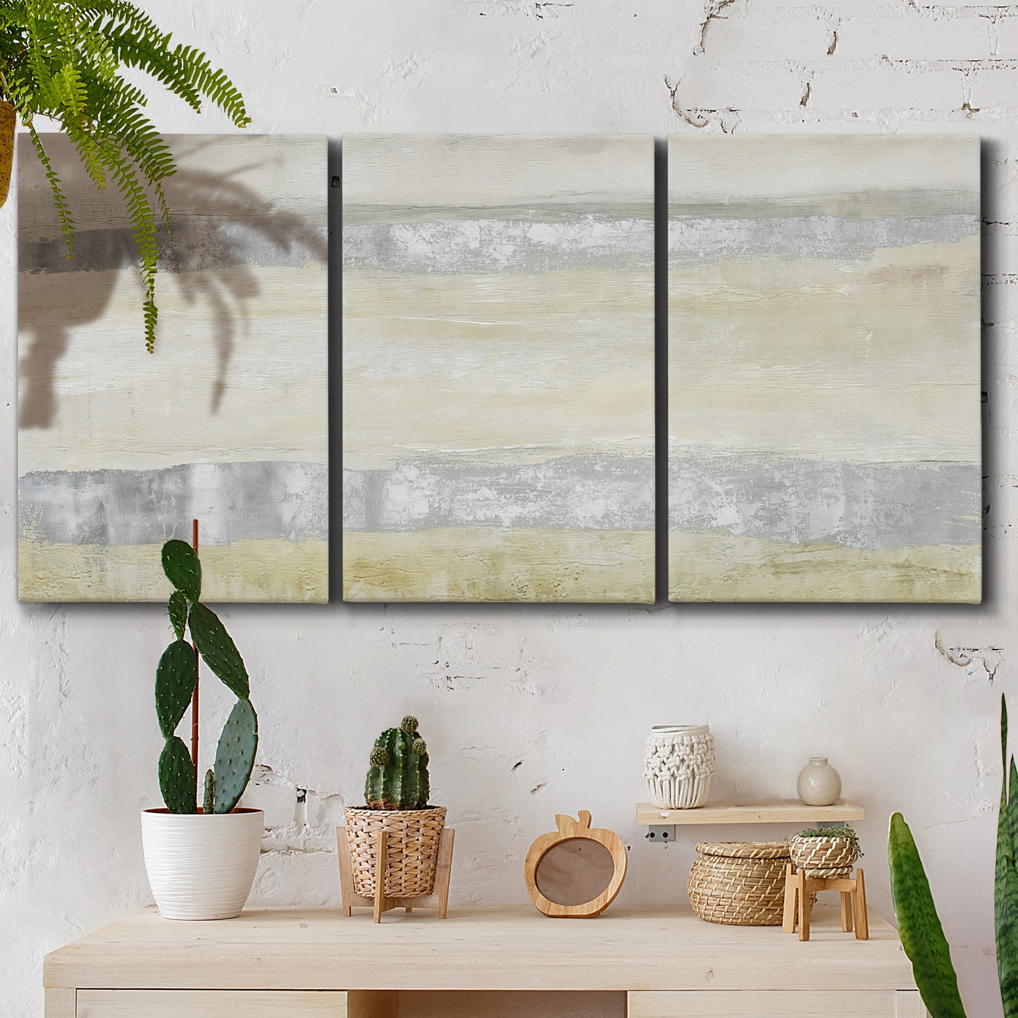 Three-panel canvas wall art featuring minimal abstract storm movement, displayed in a boho-chic entryway above a console table.