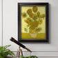 Impressionist sunflower still life painting by Vincent van Gogh in an ornate black frame with gilded inner detail displayed in a light-toned interior setting.