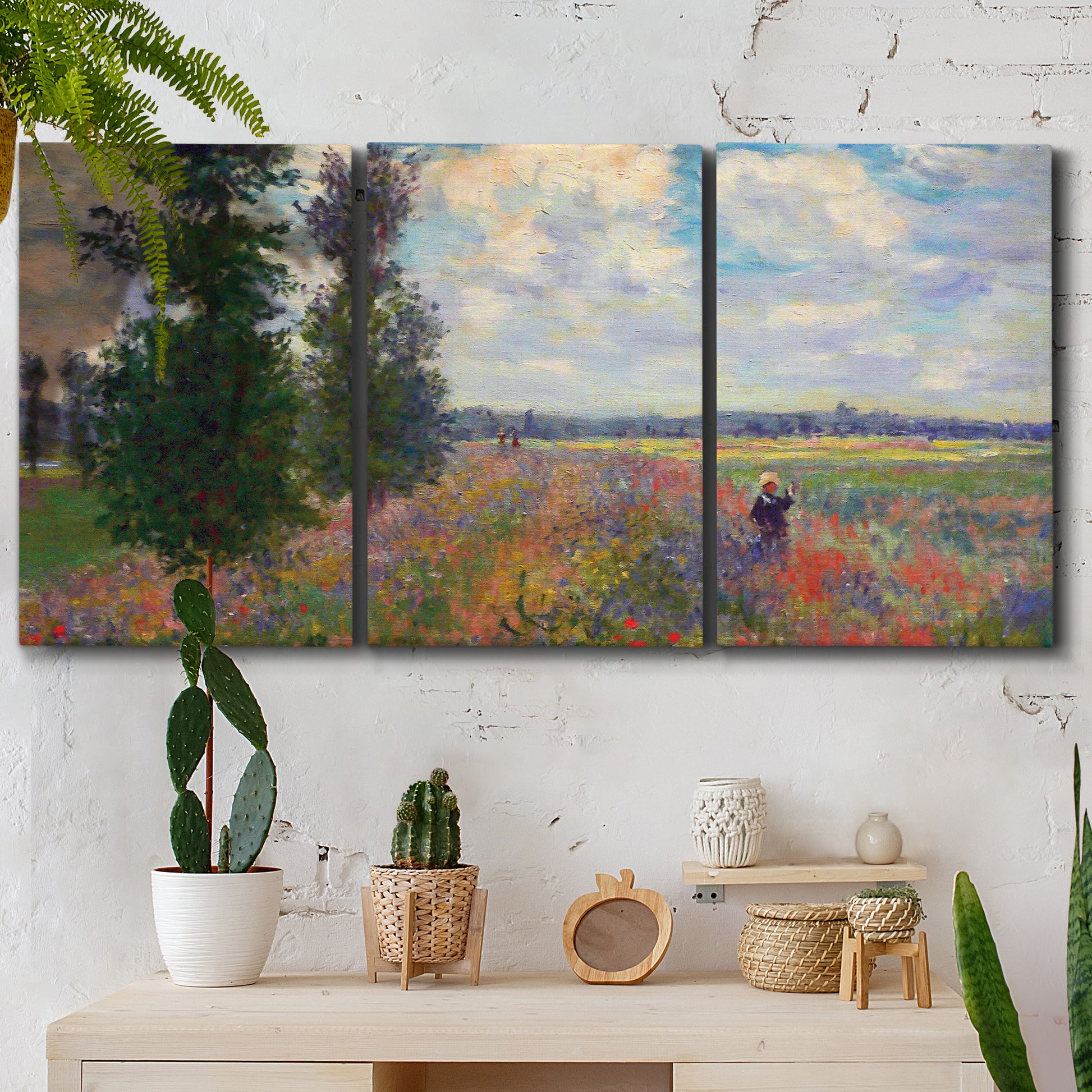 Three-panel canvas wall art featuring poppy field in open countryside, displayed in a boho-chic entryway above a console table.