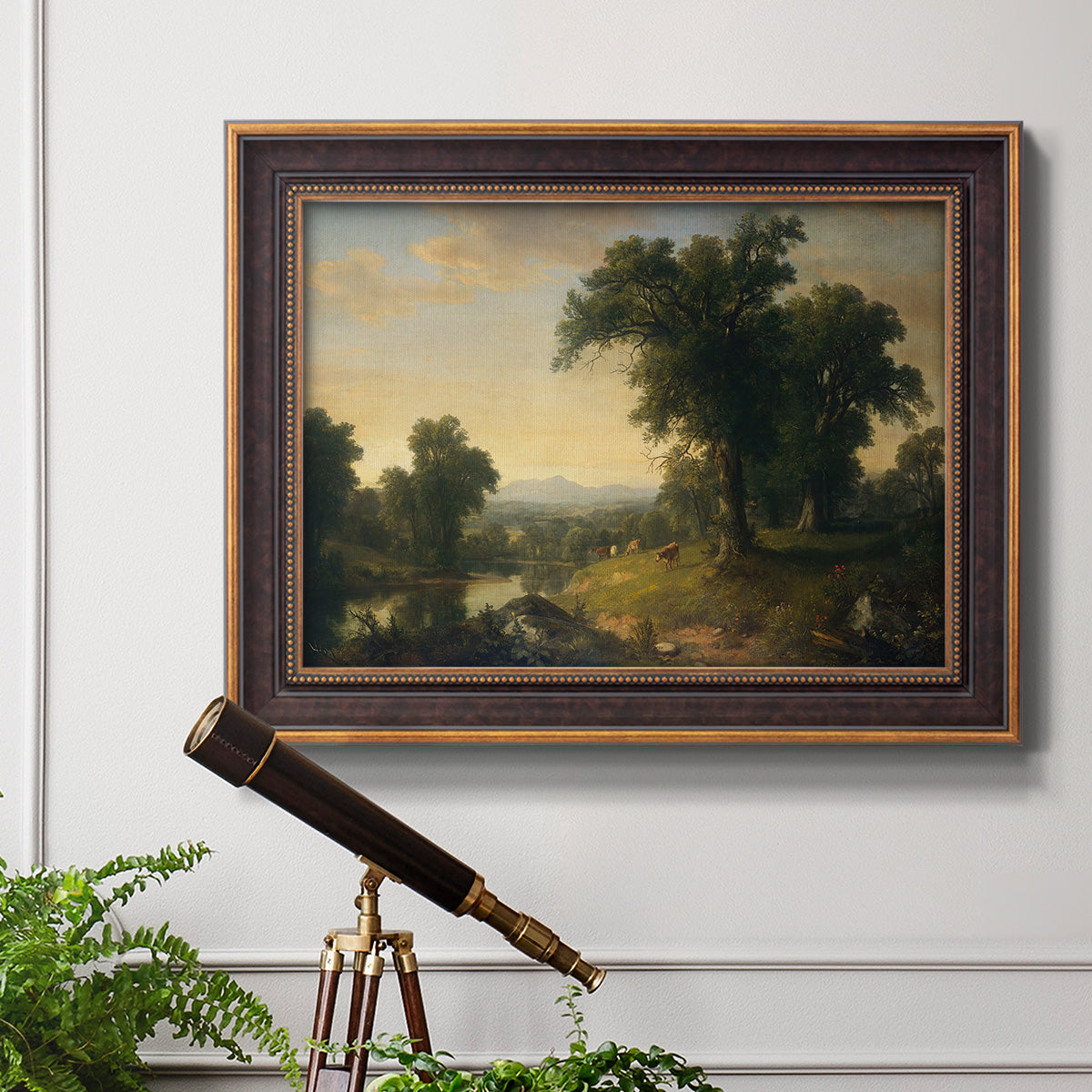 Traditional pastoral landscape painting by Asher Brown Durand in an ornate bronzed mahogany wood frame displayed in a light-toned interior setting.
