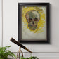 Expressive skull study painting by Vincent van Gogh in an ornate black frame with gilded inner detail displayed in a light-toned interior setting.