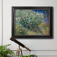 Impressionist lilac flower painting by Vincent van Gogh in an ornate black frame with gilded inner detail displayed in a light-toned interior setting.