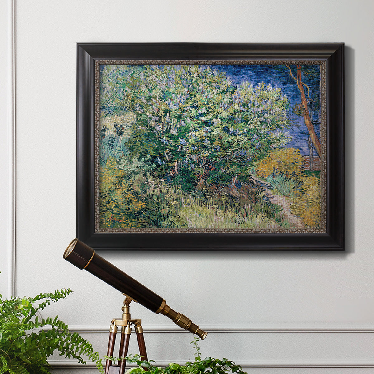 Impressionist lilac flower painting by Vincent van Gogh in an ornate black frame with gilded inner detail displayed in a light-toned interior setting.