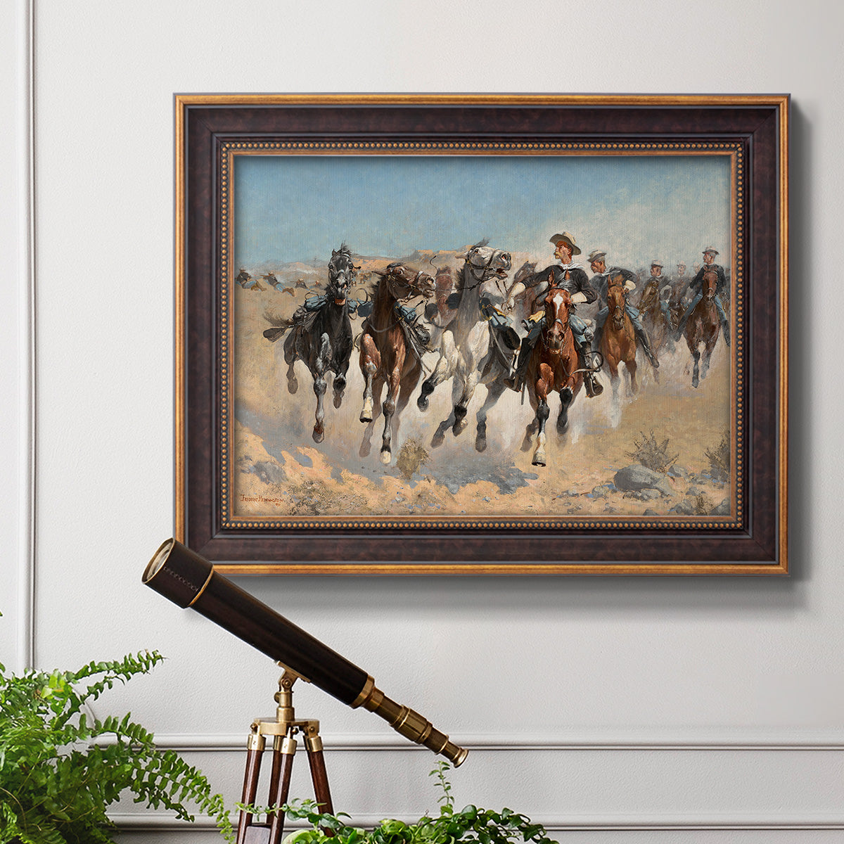 Impressionist western action scene by Frederic Remington in an ornate bronzed mahogany wood frame displayed in a light-toned interior setting.