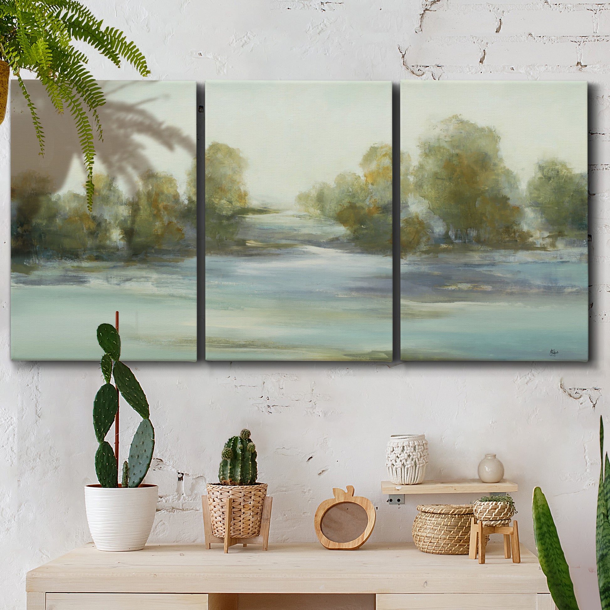 Three-panel canvas wall art featuring calming scenic landscape view, displayed in a boho-chic entryway above a console table.