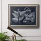 Decorative botanical foliage drawing on navy background in an ornate vintage silver frame displayed in a light-toned interior setting.