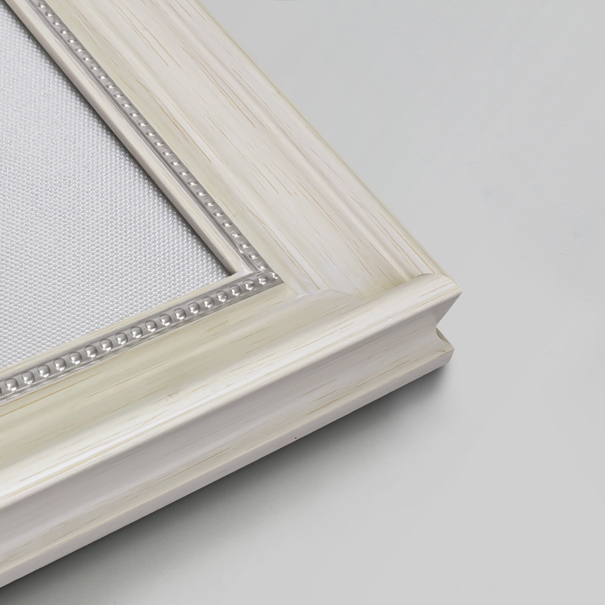 Detail of ornate weathered white frame.