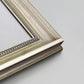 Detail of ornate champagne frame.