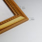 Detail of ornate antique gold frame.