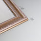 Detail of ornate traditional silver frame.