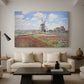 Canvas art print featuring an impressionist field of blooming tulips under bright sky, displayed in a spacious living room