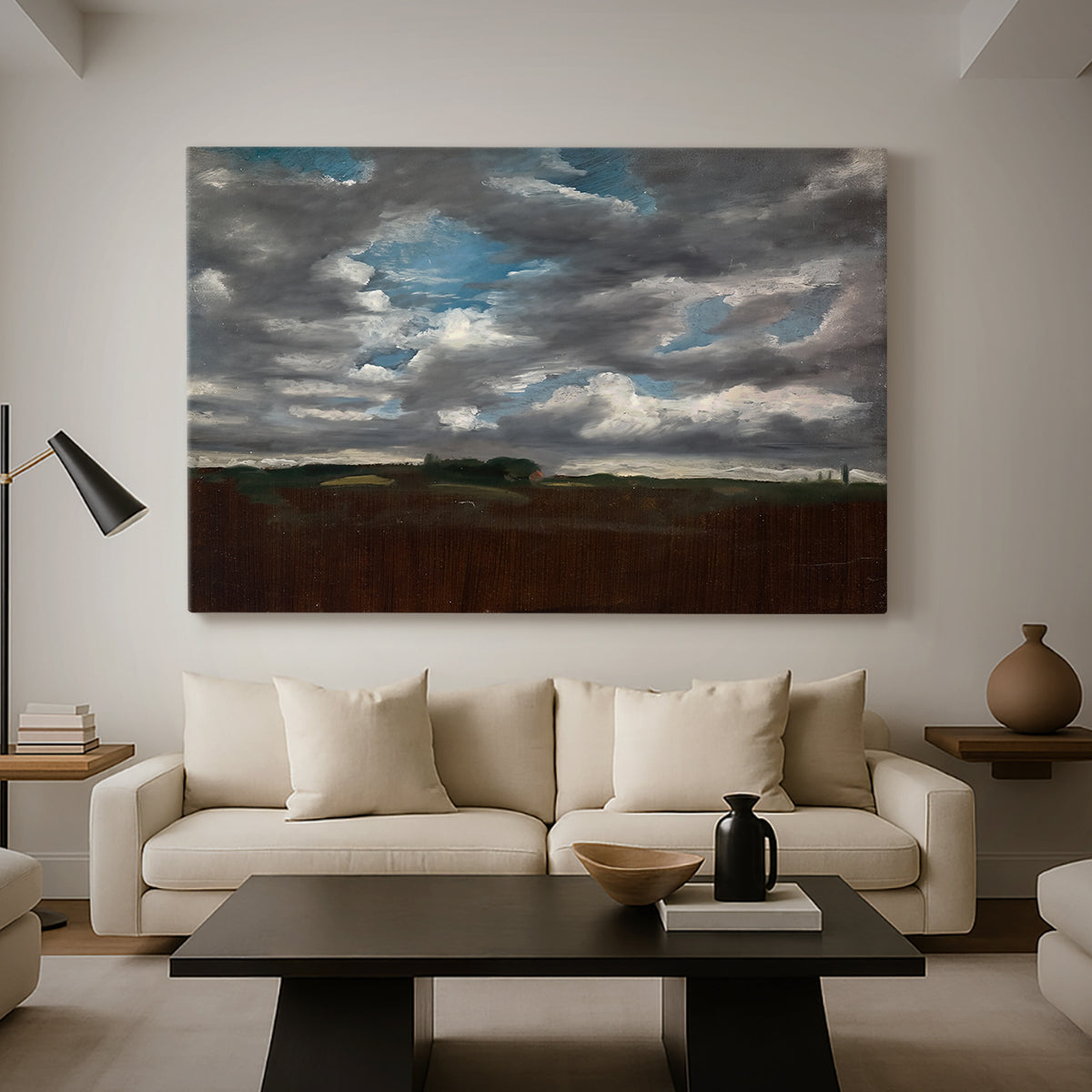 Canvas art print featuring an expansive countryside with cloud cover, displayed in a spacious living room