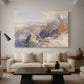 Canvas art print featuring a panoramic alpine view with snow and rocky cliffs, displayed in a spacious living room