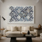 Canvas art print featuring a decorative composition featuring branching stems and leaves, displayed in a spacious living room