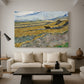Canvas art print featuring a post-impressionist farm scene with cultivated land and open horizon, displayed in a spacious living room