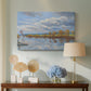 Canvas art print featuring a pointillist landscape featuring water, displayed above a styled console table