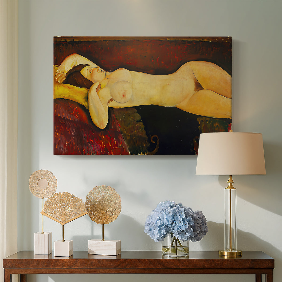 Canvas art print featuring a stylized female nude resting on fabric with warm tones, displayed above a styled console table