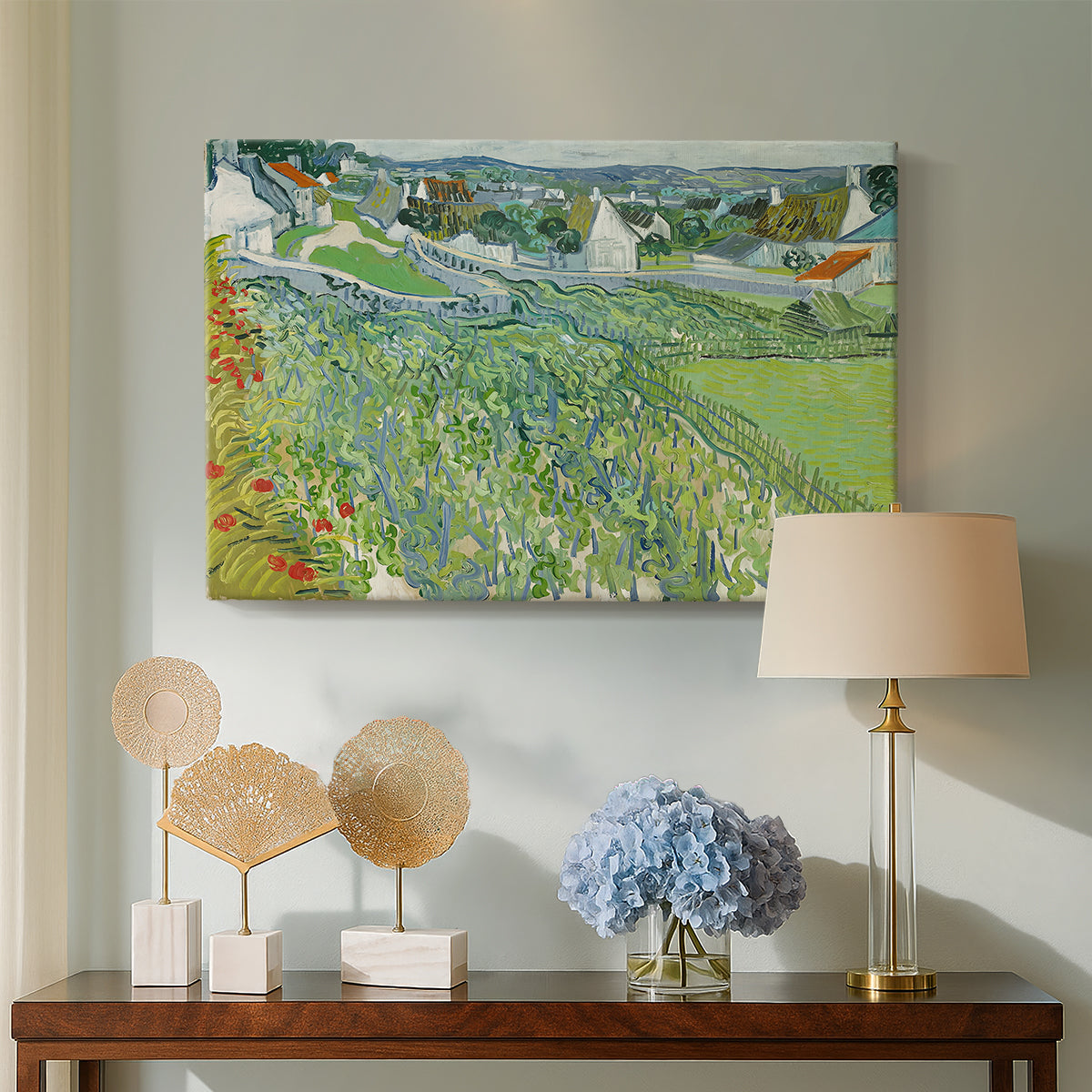 Canvas art print featuring a post-impressionist countryside composition with crops, displayed above a styled console table