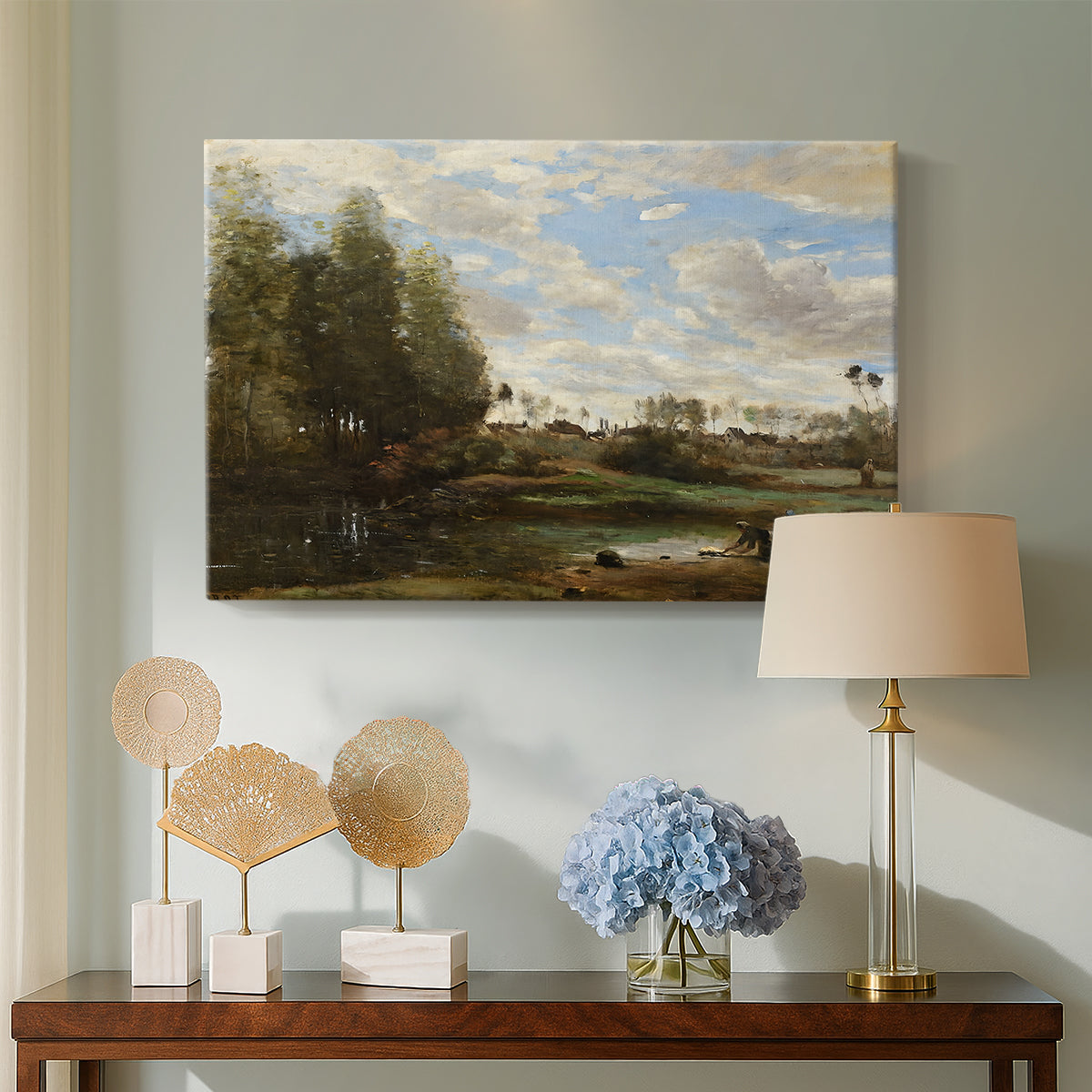 Canvas art print featuring a soft landscape with figures and foliage near shoreline, displayed above a styled console table