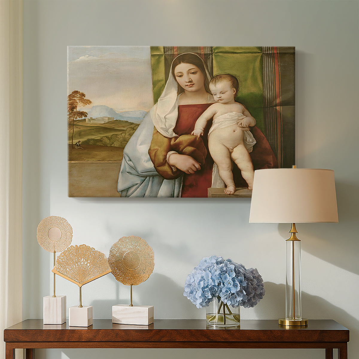 Canvas art print featuring a Renaissance composition of Madonna and child against landscape backdrop, displayed above a styled console table