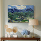 Canvas art print featuring a landscape combining foreground grove and distant peaks, displayed above a styled console table