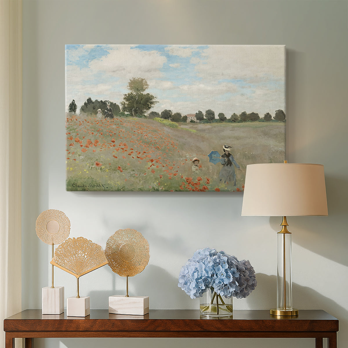 Canvas art print featuring a bright meadow filled with poppies under open sky, displayed above a styled console table