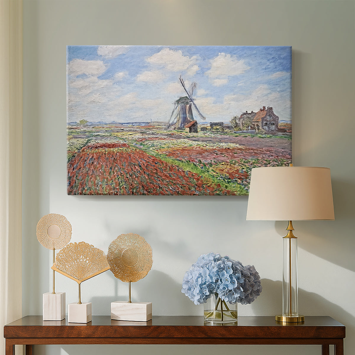 Canvas art print featuring an impressionist field of blooming tulips under bright sky, displayed above a styled console table