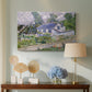 Canvas art print featuring a post-impressionist cityscape with rooftops and vegetation, displayed above a styled console table