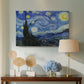 Canvas art print featuring a post-impressionist night scene with village beneath moving sky, displayed above a styled console table