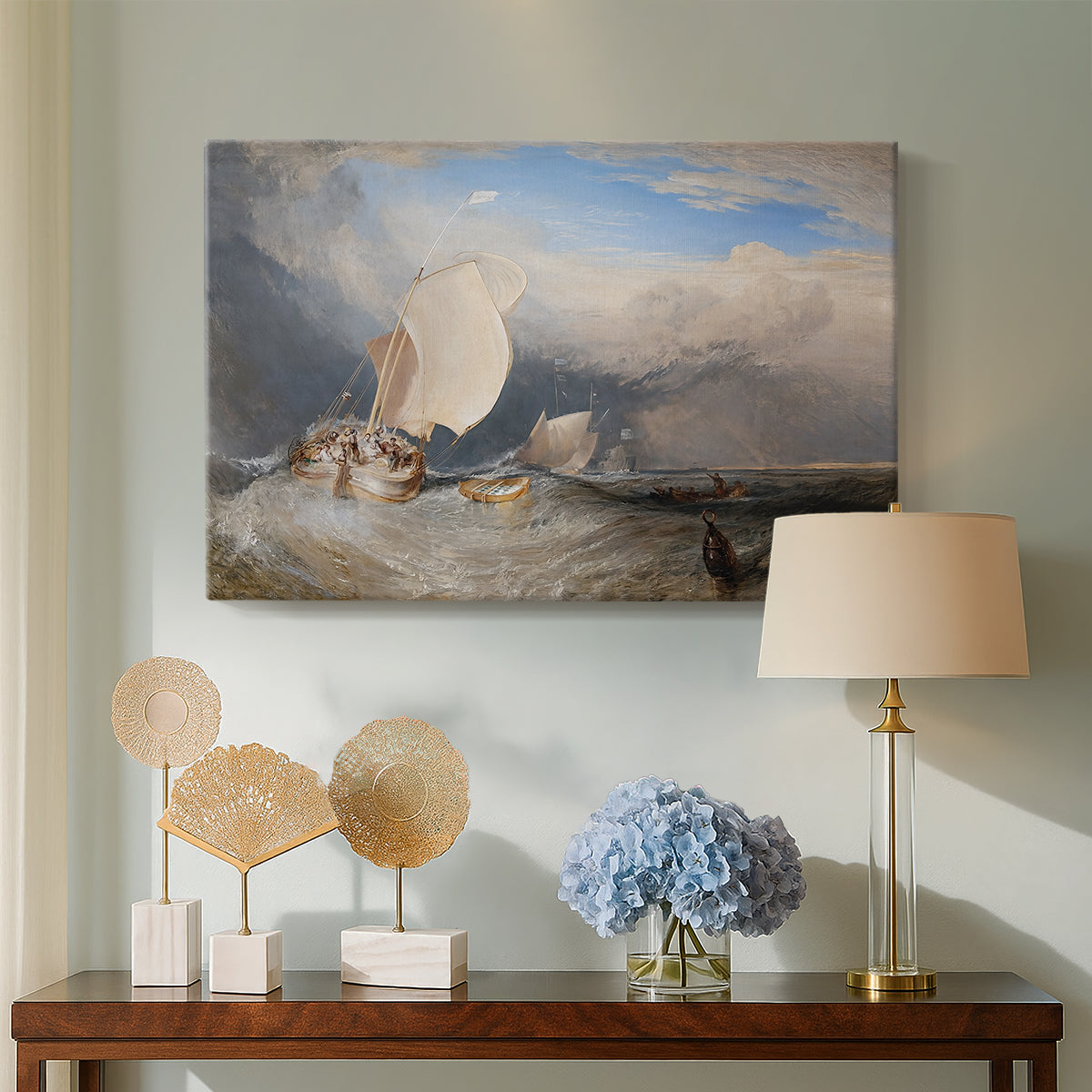 Canvas art print featuring a maritime scene with boats and people gathered along shoreline, displayed above a styled console table