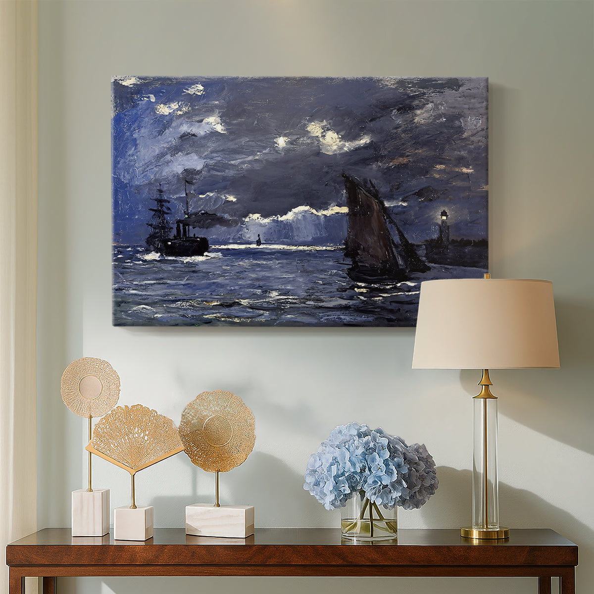Canvas art print featuring a dramatic ocean scene with light reflecting across water at night, displayed above a styled console table