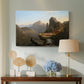 Canvas art print featuring an expansive landscape featuring cliffs, water, and distant mountains, displayed above a styled console table