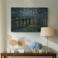 Canvas art print featuring a riverside view with figures near water under star-filled sky, displayed above a styled console table