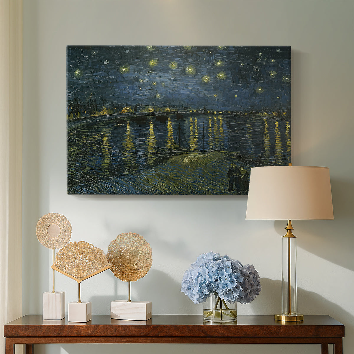Canvas art print featuring a riverside view with figures near water under star-filled sky, displayed above a styled console table