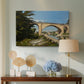 Canvas art print featuring a scenic view of bridge with water and surrounding environment, displayed above a styled console table