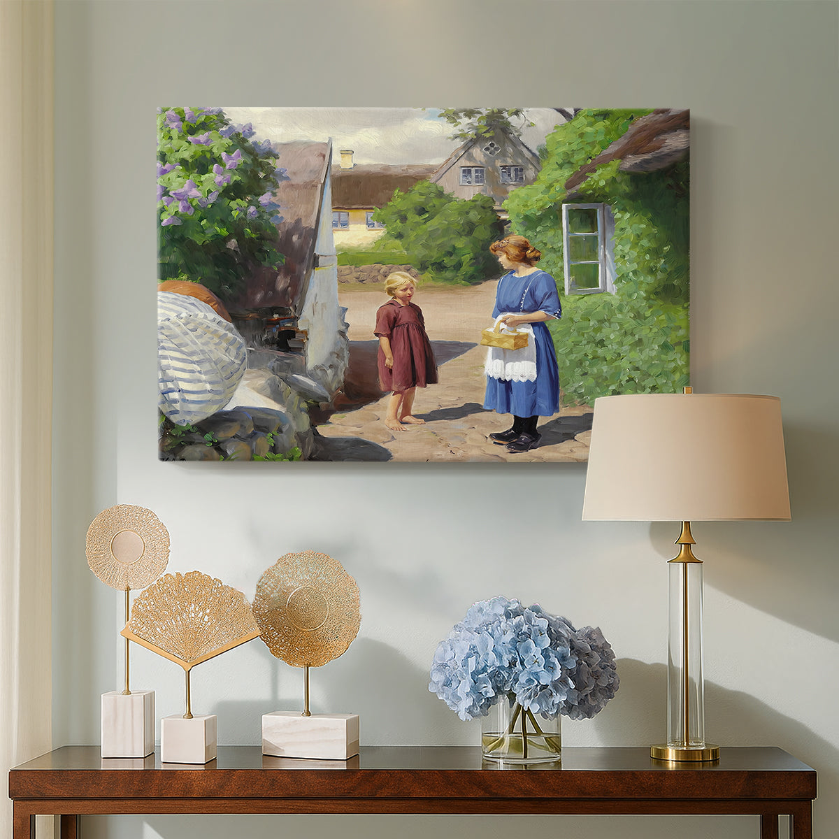 Canvas art print featuring a countryside setting with homes and people outdoors, displayed above a styled console table