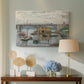 Canvas art print featuring a calm water scene with bridge fading into cloudy sky, displayed above a styled console table