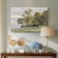 Canvas art print featuring a natural setting with water, trees, and open sky, displayed above a styled console table