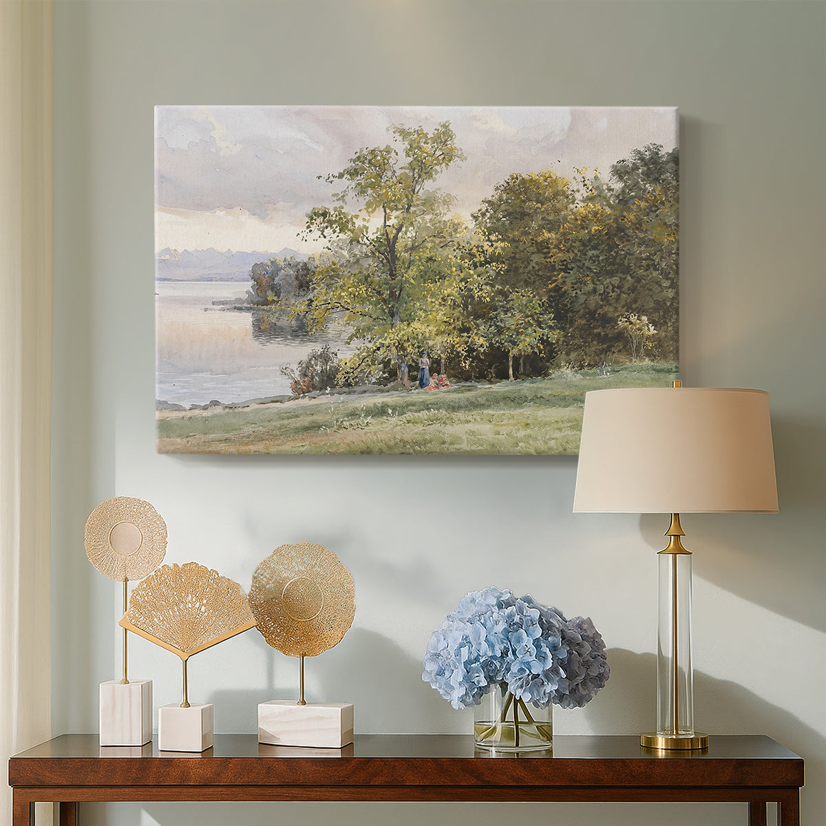 Canvas art print featuring a natural setting with water, trees, and open sky, displayed above a styled console table