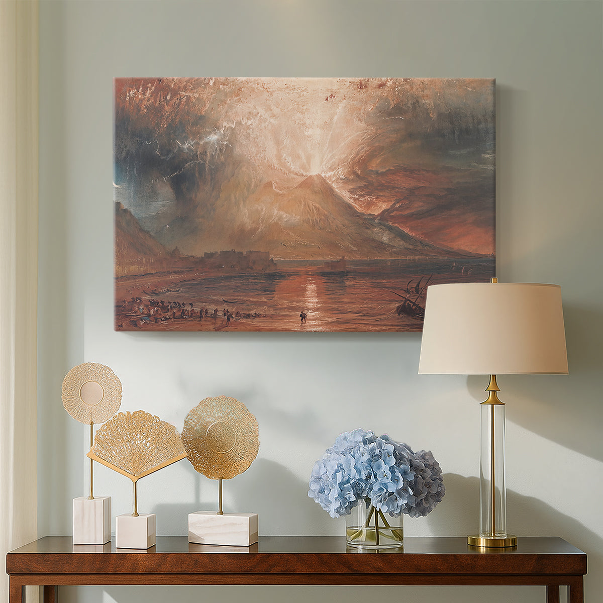 Canvas art print featuring an expressive depiction of erupting volcano, displayed above a styled console table