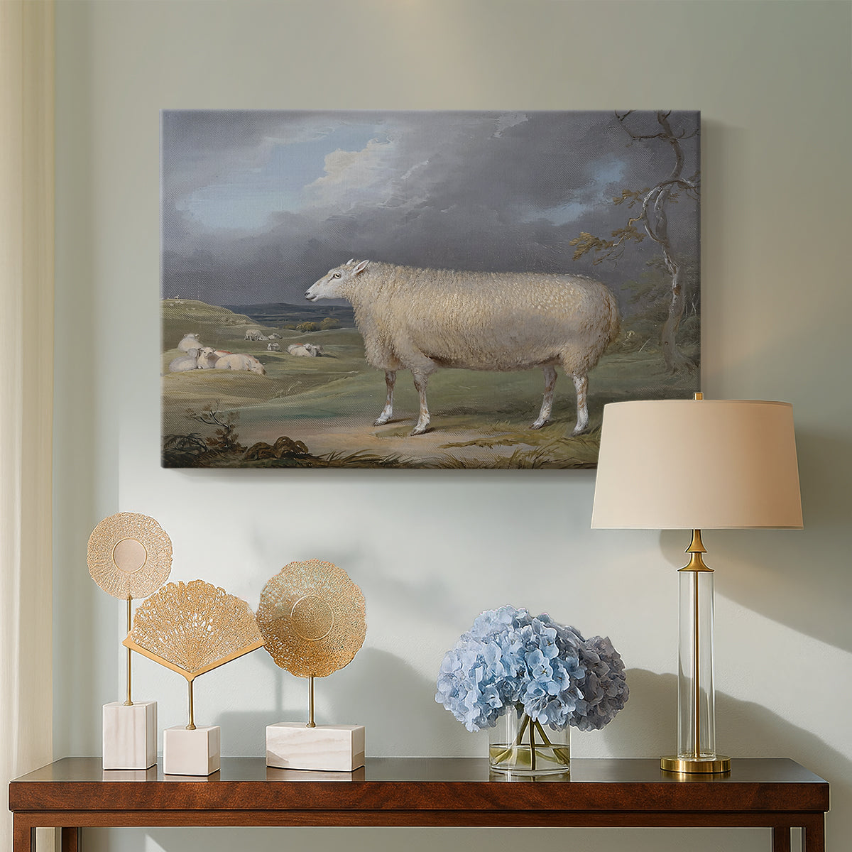 Canvas art print featuring a realistic depiction of sheep in countryside setting, displayed above a styled console table