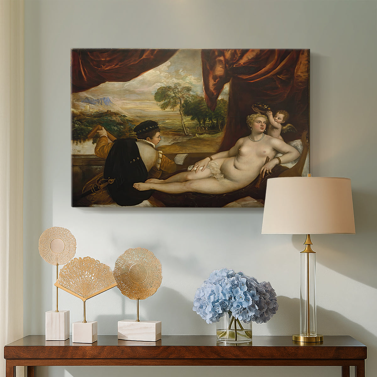 Canvas art print featuring a Renaissance composition of nude figure and lute player outdoors, displayed above a styled console table