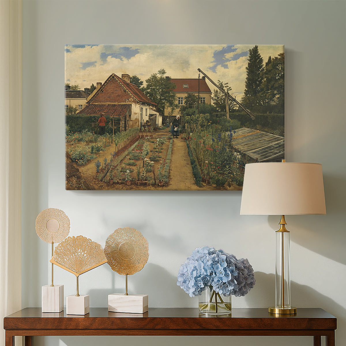 Canvas art print featuring an outdoor space with greenery surrounding small structure, displayed above a styled console table