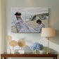 Canvas art print featuring a beach setting with people relaxing under umbrellas, displayed above a styled console table