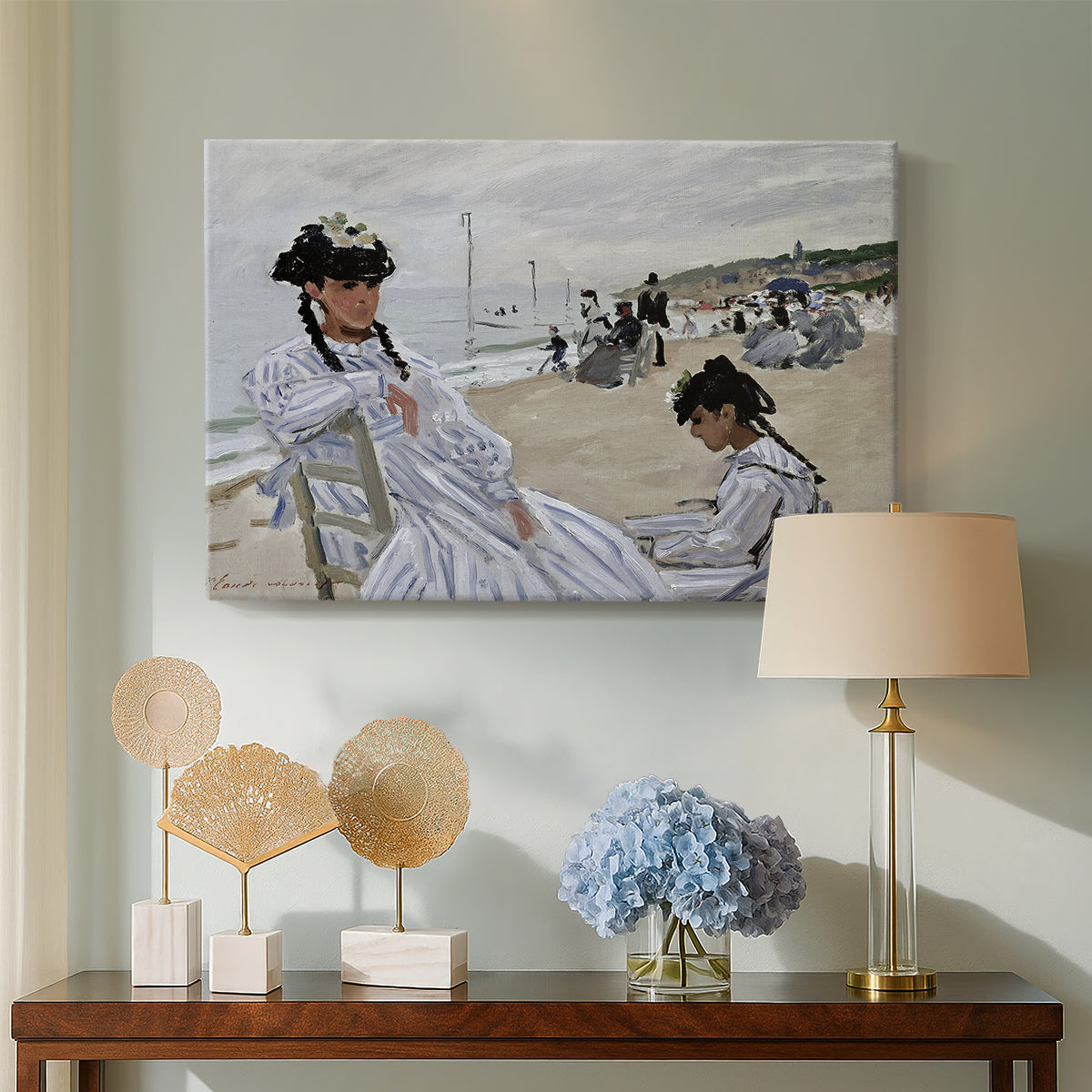 Canvas art print featuring a beach setting with people relaxing under umbrellas, displayed above a styled console table