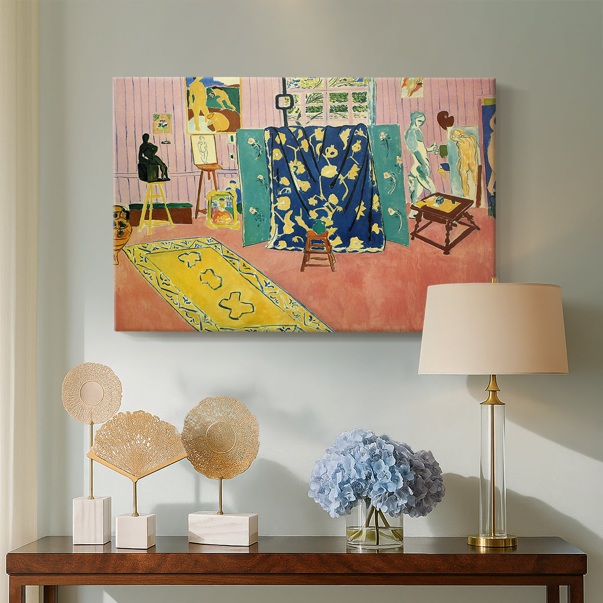 Canvas art print featuring an expressive interior of a bright pink workspace, displayed above a styled console table
