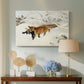 Canvas art print featuring a red fox crossing snow-covered ground under pale sky, displayed above a styled console table