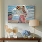 Canvas art print featuring a bright coastal composition with figures and shoreline, displayed above a styled console table